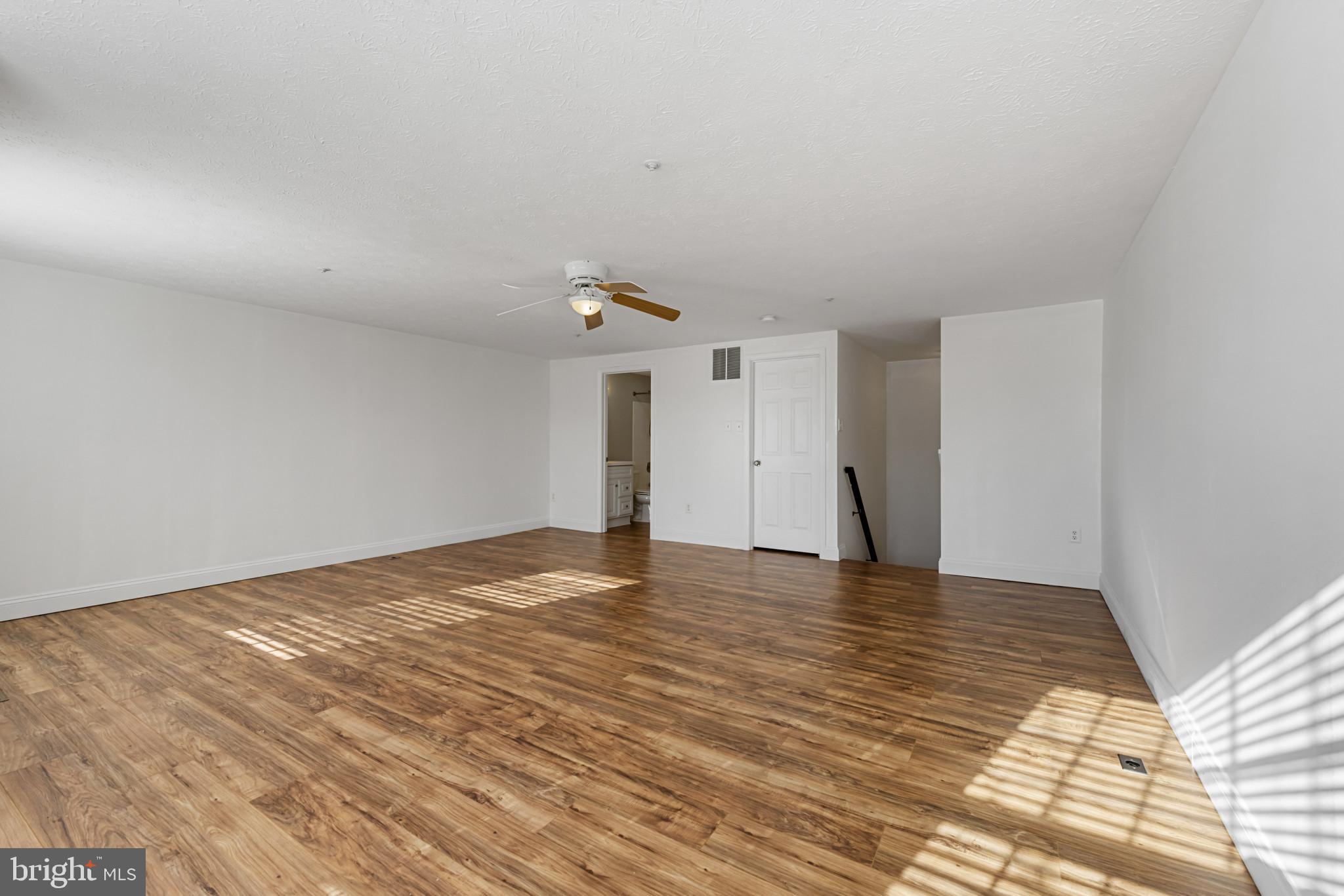 4122 Maple Path Circle, Unit 55 Nottingham, MD 21236 - Photo 16 of 27 Spacious, sunlit room with warm wood floors.