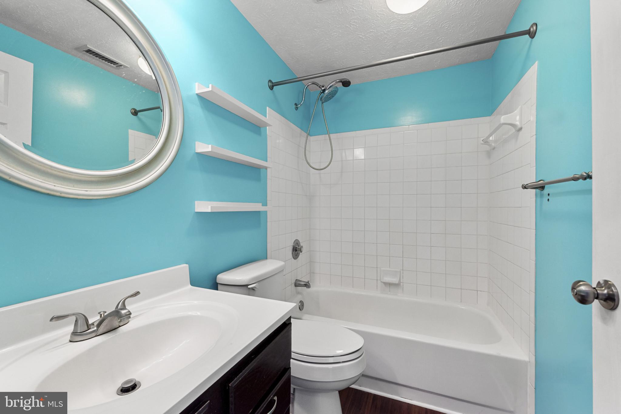 4122 Maple Path Circle, Unit 55 Nottingham, MD 21236 - Photo 19 of 27 Vibrant blue bathroom with modern fixtures.