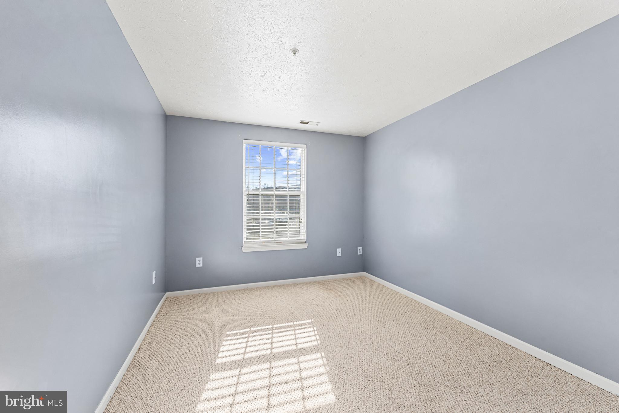 4122 Maple Path Circle, Unit 55 Nottingham, MD 21236 - Photo 22 of 27 Bright, airy room with soft gray walls.