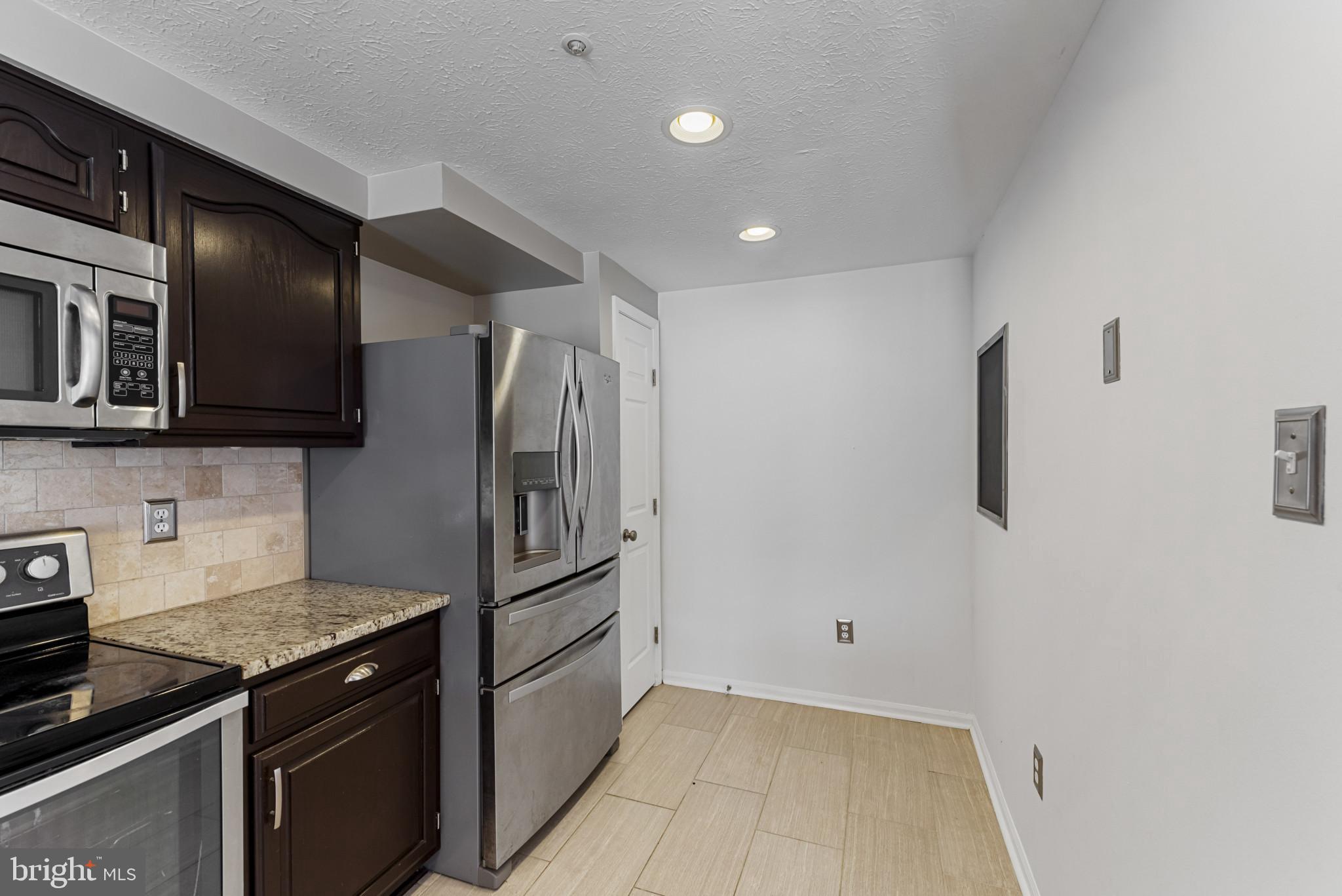 4122 Maple Path Circle, Unit 55 Nottingham, MD 21236 - Photo 4 of 27 Modern kitchen with sleek appliances.