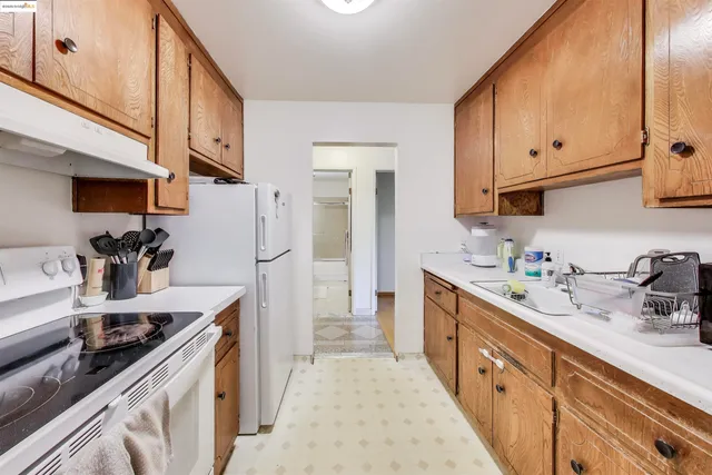 a kitchen with sink a stove and refrigerator