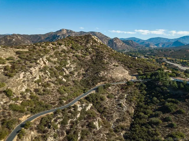 a view of a large mountain with a mountain in the background