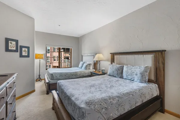 a bedroom with a large bed and a window