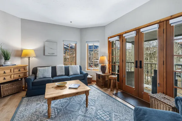 a living room with furniture and a lamp