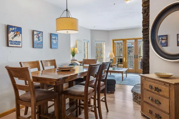 a view of a dining room with furniture and a chandelier