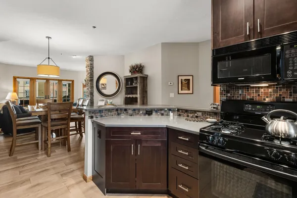 a kitchen with a stove and a microwave