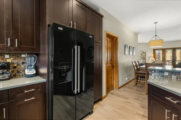 a kitchen with stainless steel appliances granite countertop a refrigerator stove and cabinets