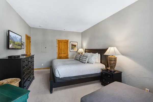 a bedroom with a bed and a television