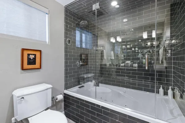 a bathroom with a toilet and a shower