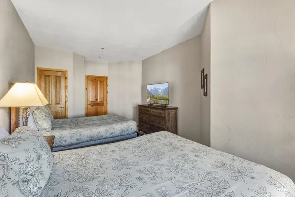 a bedroom with a bed and a flat screen tv