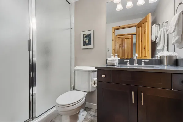 a bathroom with a sink vanity mirror and toilet