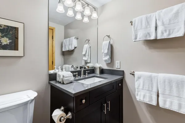 a white toilet sitting next to a bathroom sink