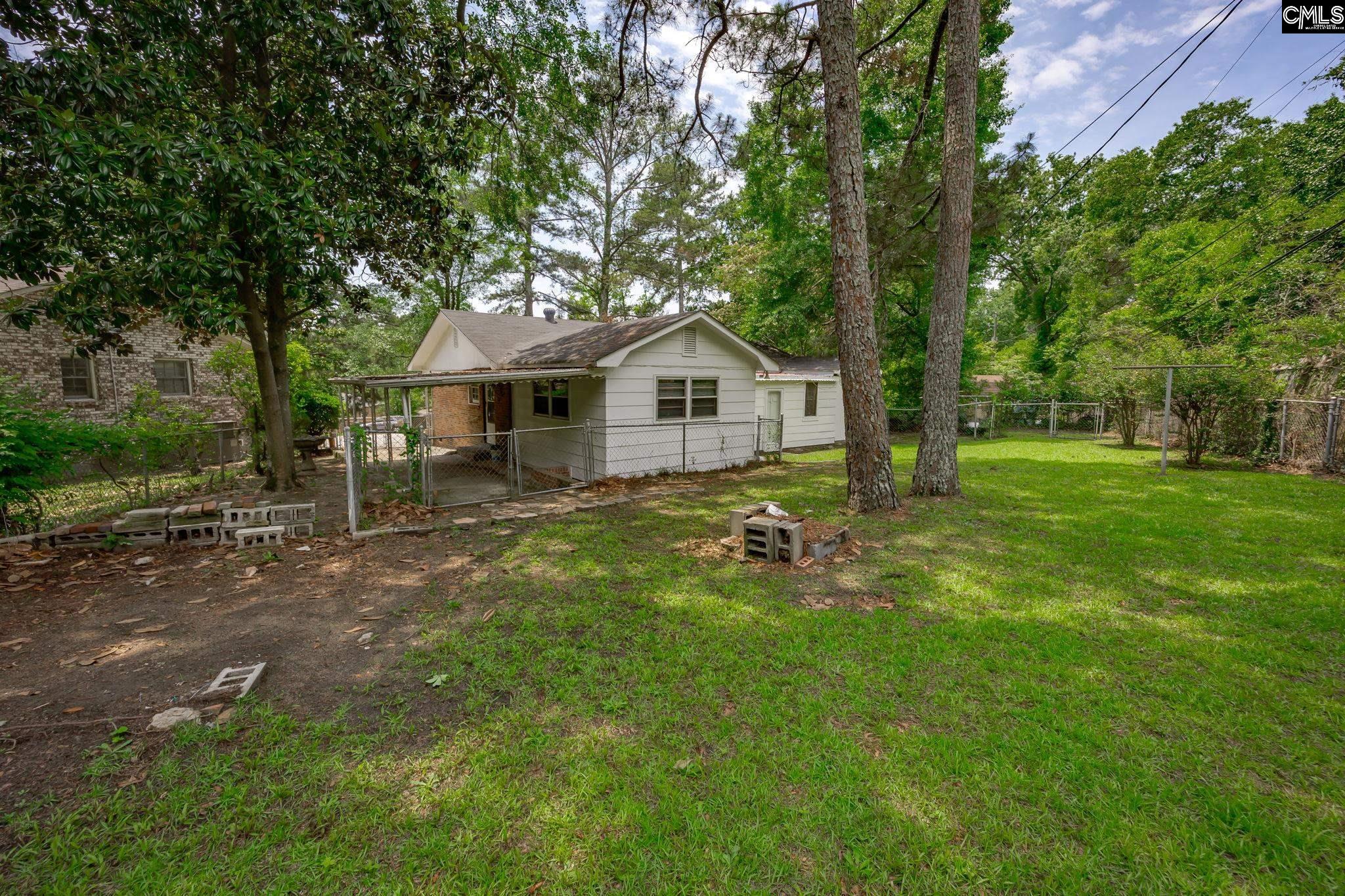 5666 Middleton Court Columbia, SC 29203 - Photo 38 of 42 a front view of a house with garden and tree