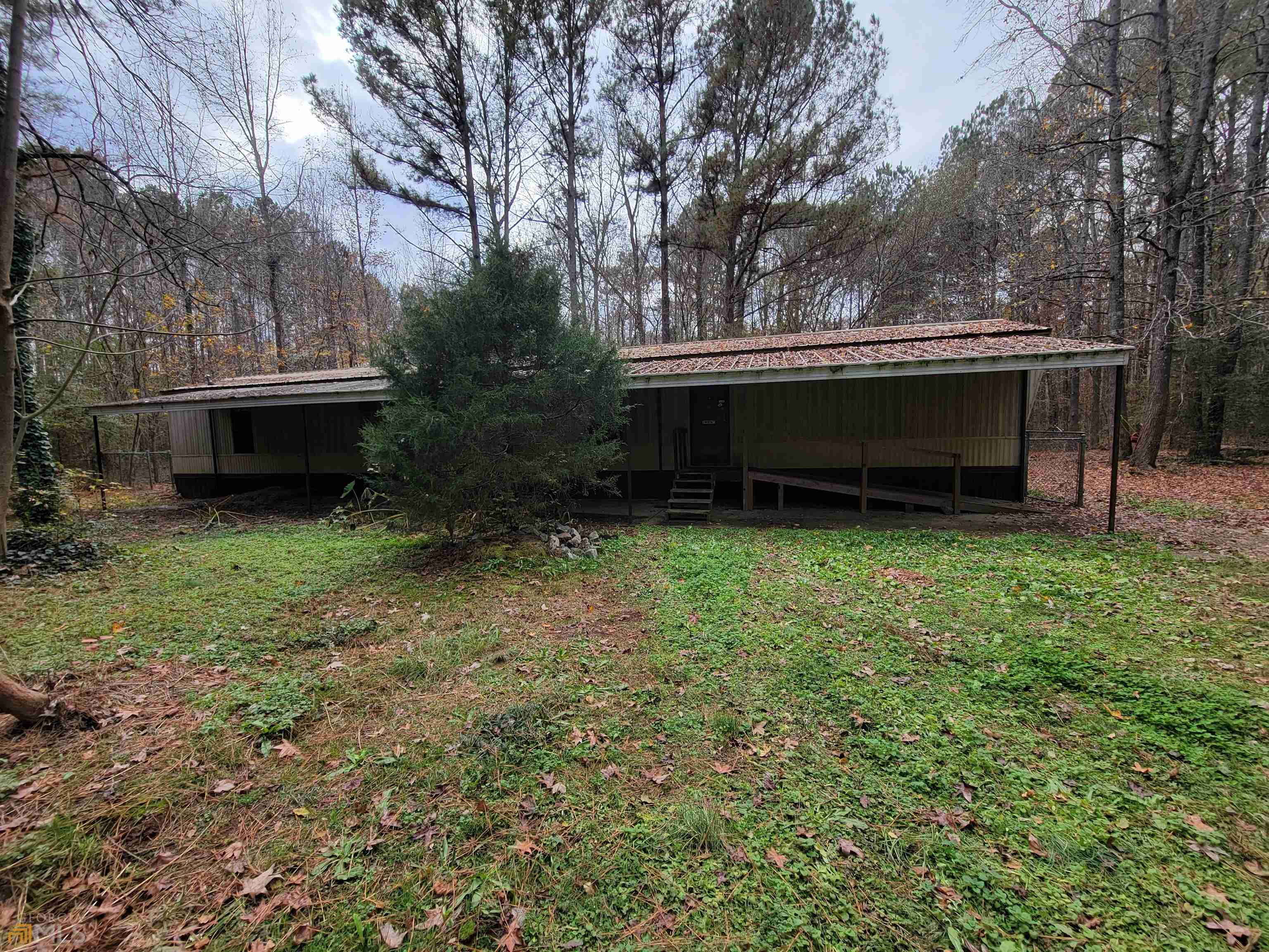 196 Wani Road Griffin, GA 30224 - Photo 1 of 1 a view of backyard with wooden fence and a bench