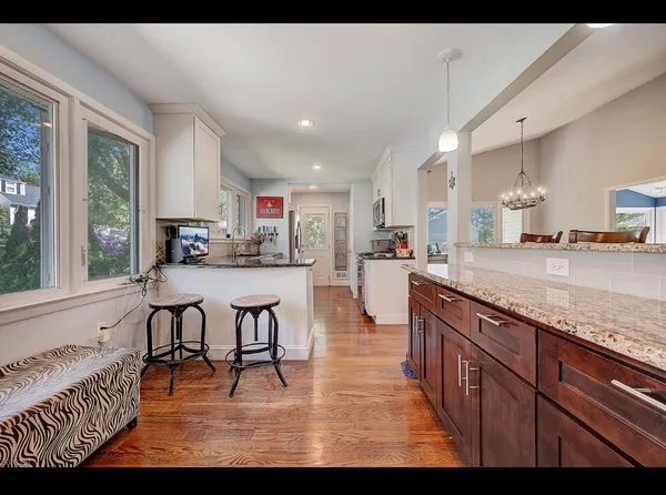 a kitchen with stainless steel appliances kitchen island granite countertop a refrigerator and a stove top oven