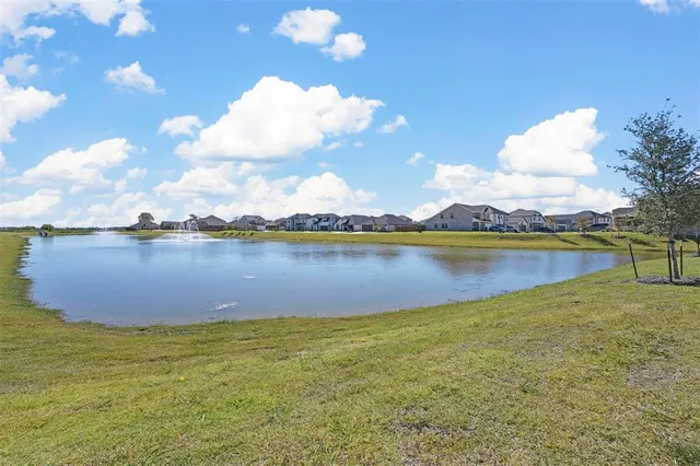 a view of a lake with houses in the background
