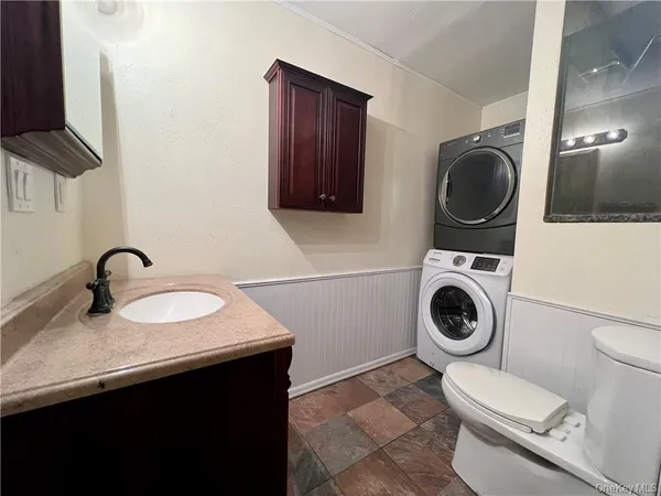 a bathroom with a toilet sink and washing machine