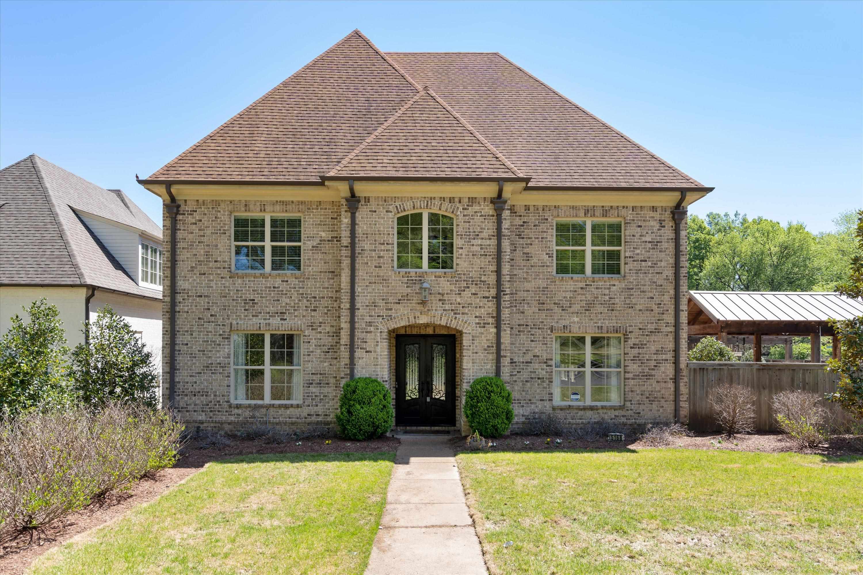 5168 Barry Road Memphis, TN 38117 - Photo 1 of 25 a front view of a house with a yard and garage