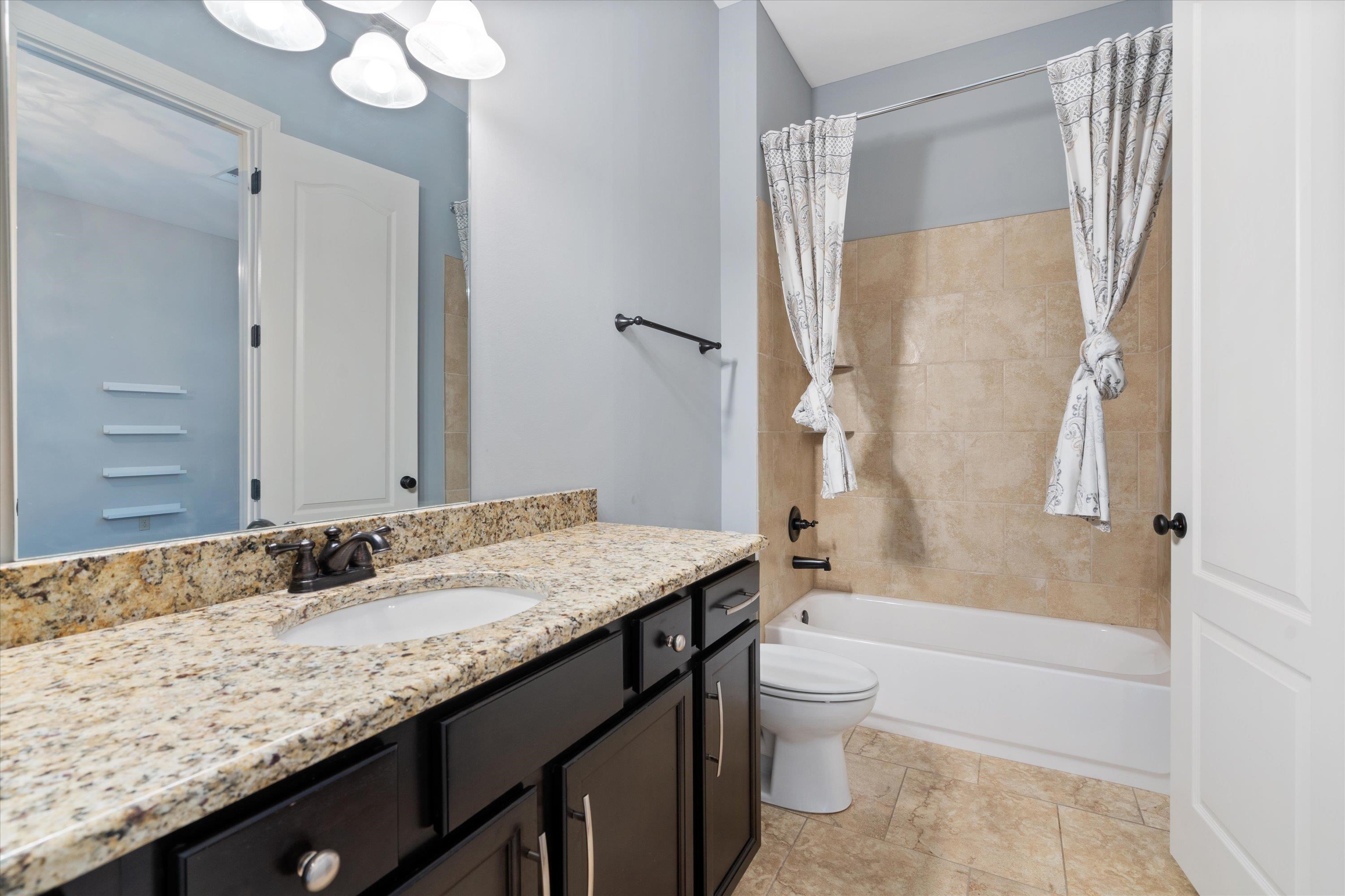 5168 Barry Road Memphis, TN 38117 - Photo 12 of 25 a bathroom with a granite countertop sink toilet and shower