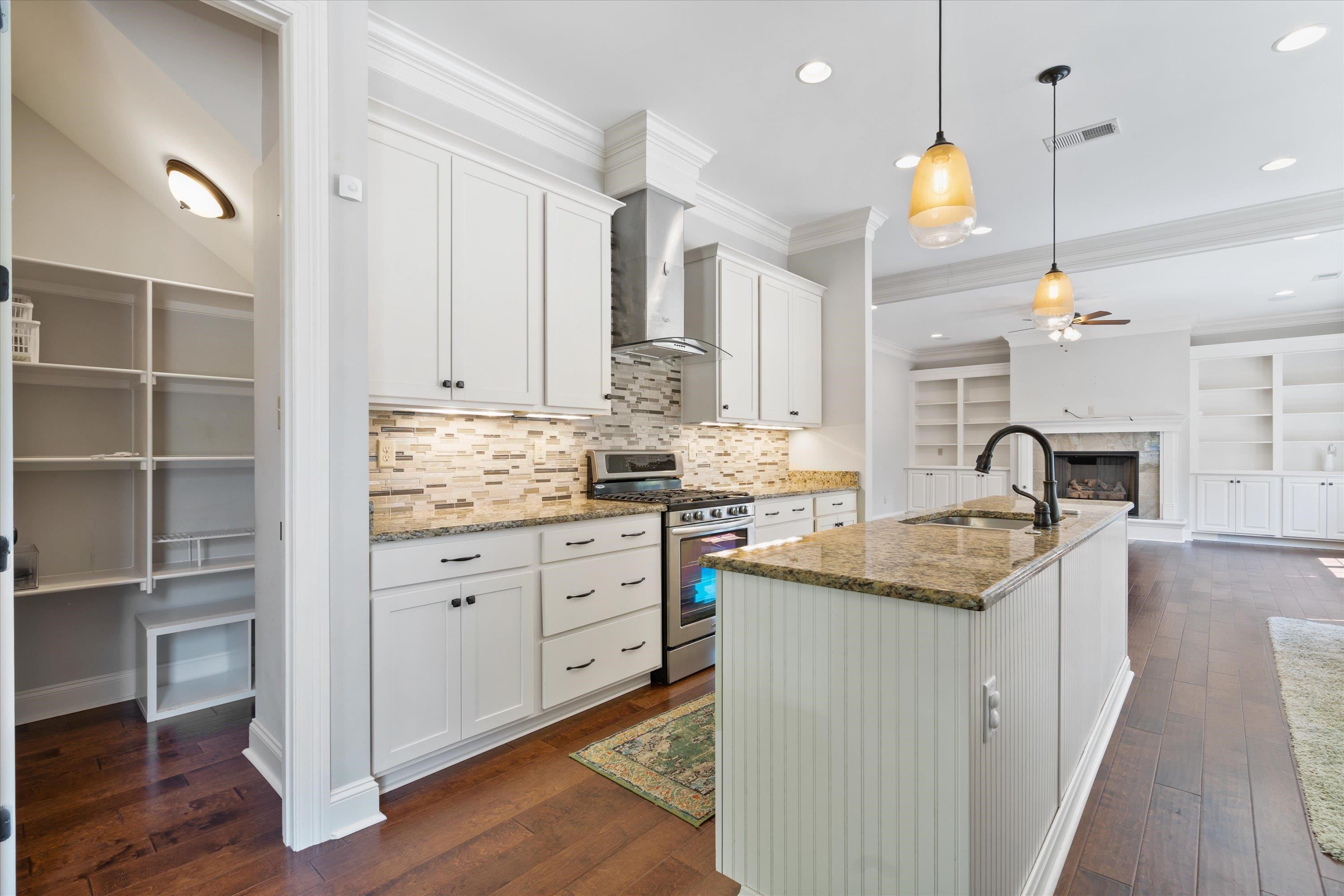 5168 Barry Road Memphis, TN 38117 - Photo 4 of 25 a kitchen with granite countertop a sink stove and cabinets