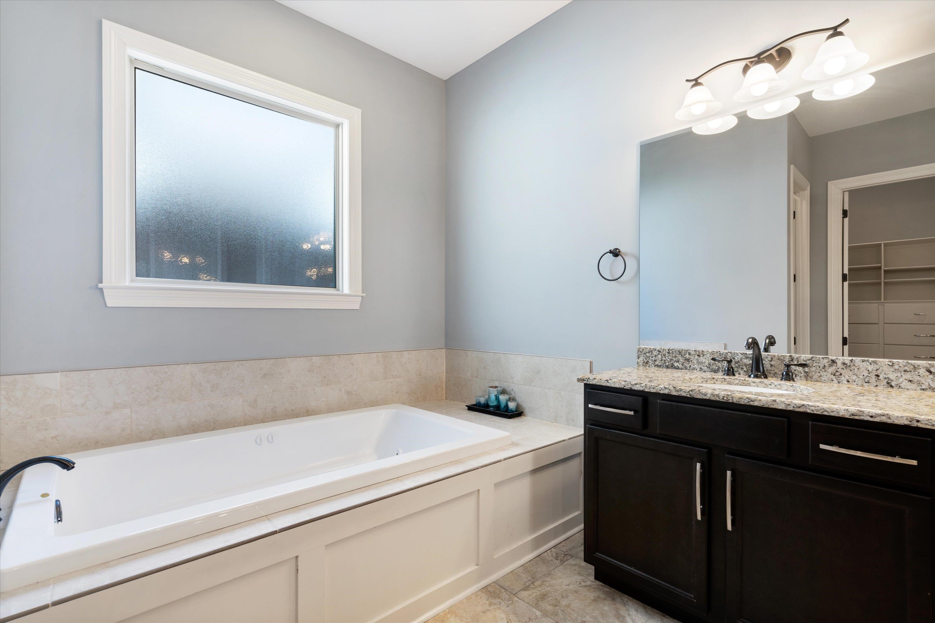 5168 Barry Road Memphis, TN 38117 - Photo 9 of 25 a bathroom with a sink and a bathtub