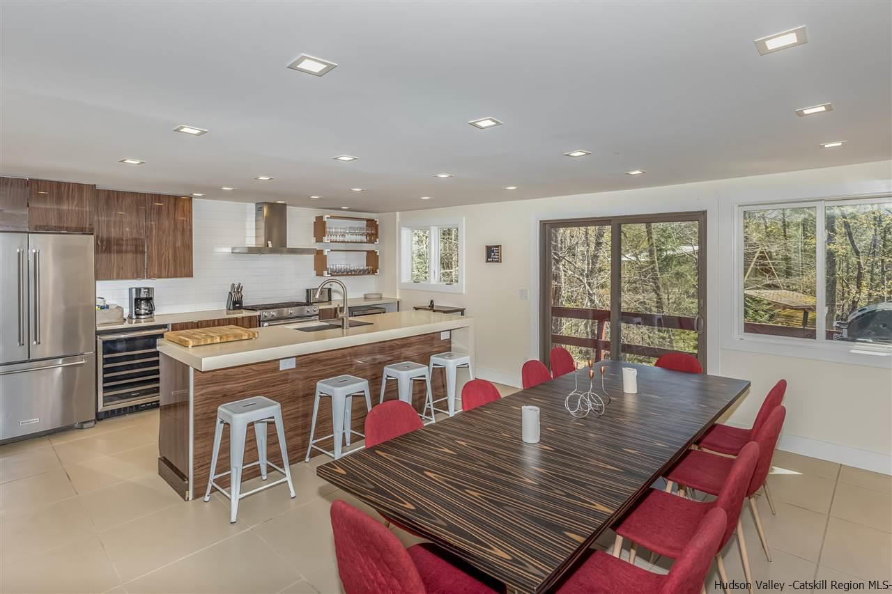 96 Lake Road Hunter, NY 12442 - Photo 12 of 35 a large kitchen with a table chairs refrigerator and cabinets
