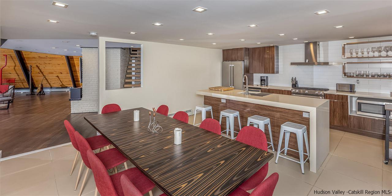 96 Lake Road Hunter, NY 12442 - Photo 13 of 35 a open kitchen with stainless steel appliances granite countertop a stove a sink dishwasher and a dining table with the kitchen view
