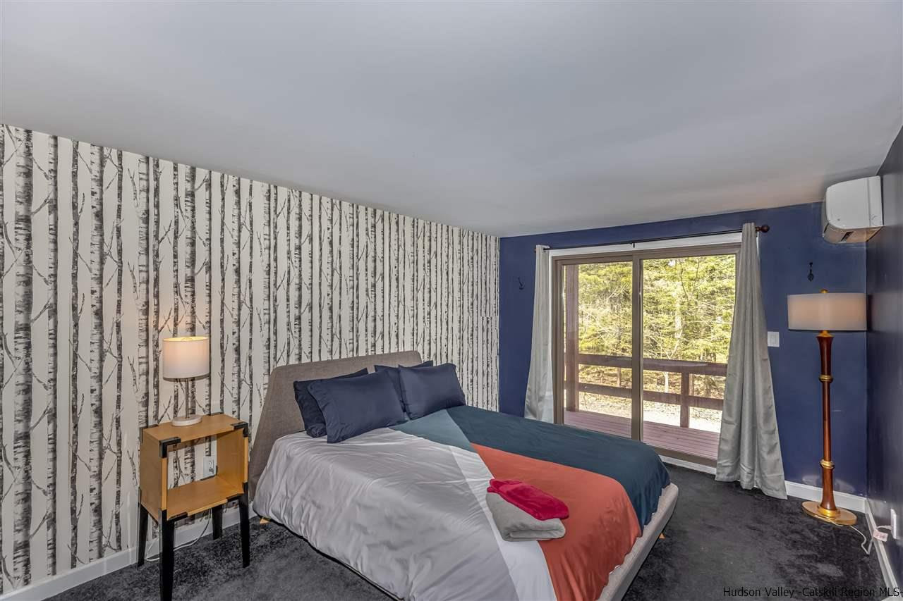 96 Lake Road Hunter, NY 12442 - Photo 17 of 35 a bedroom with a bed and wooden floor