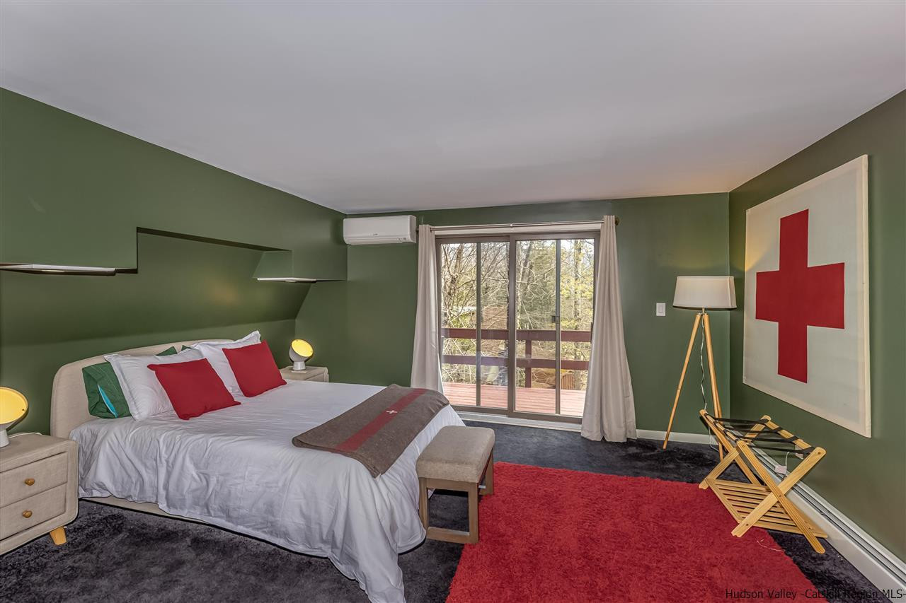 96 Lake Road Hunter, NY 12442 - Photo 19 of 35 a bedroom with a bed and a window