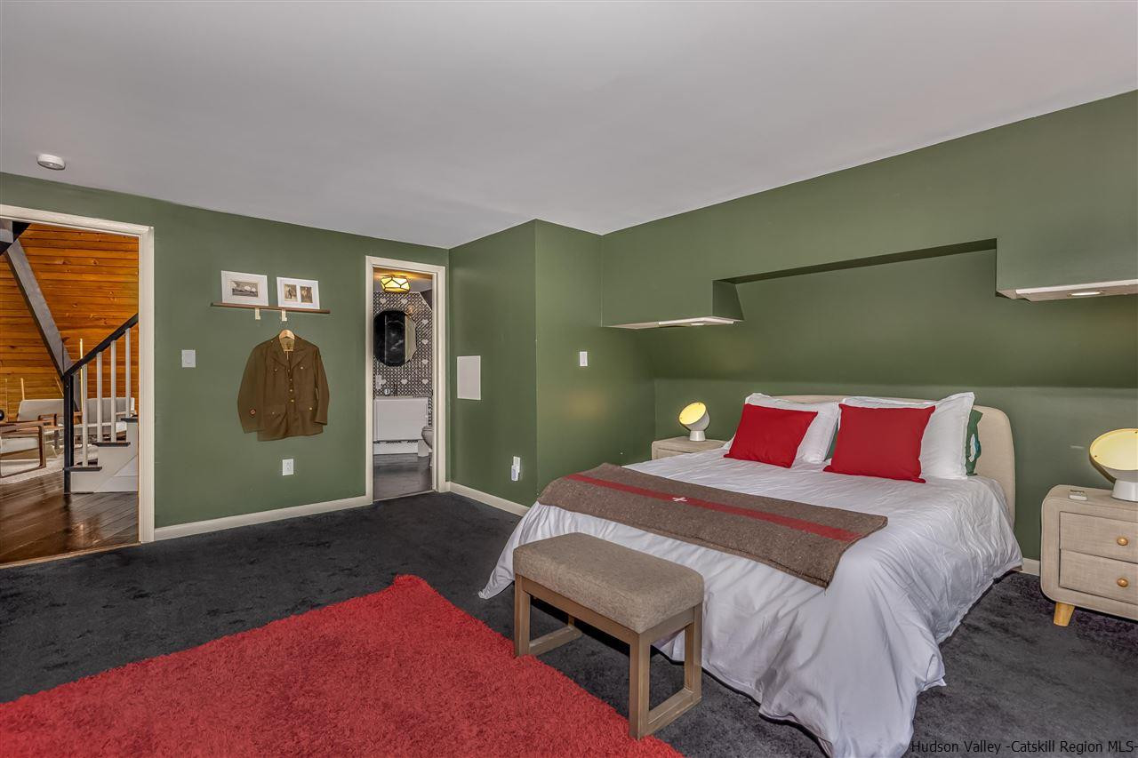 96 Lake Road Hunter, NY 12442 - Photo 20 of 35 a bedroom with a bed and a mirror