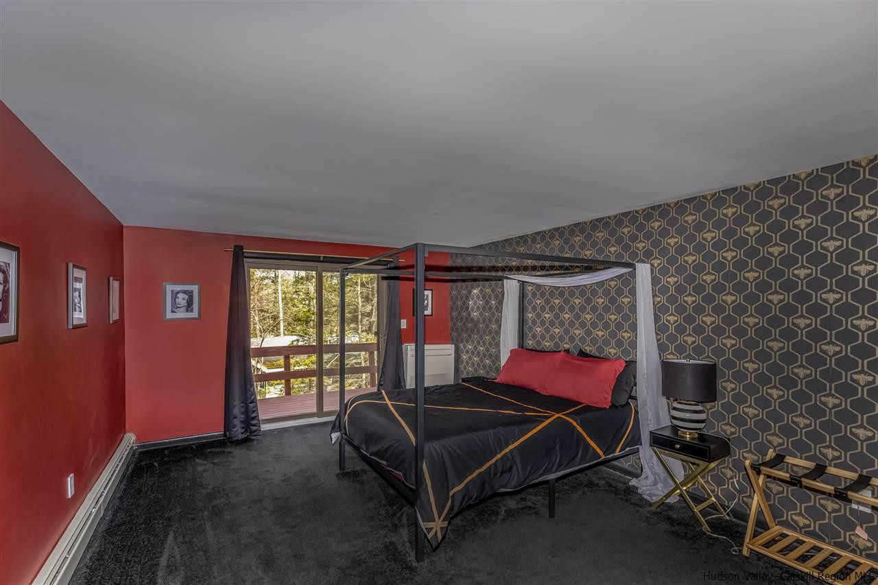 96 Lake Road Hunter, NY 12442 - Photo 24 of 35 a bedroom with a bed and a window