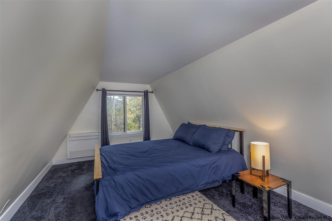 96 Lake Road Hunter, NY 12442 - Photo 30 of 35 a bedroom with a bed and a window