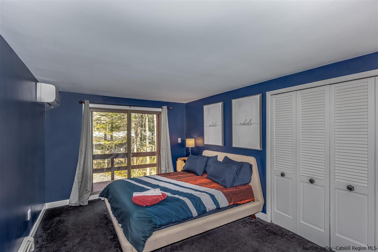 96 Lake Road Hunter, NY 12442 - Photo 31 of 35 a bedroom with a bed and a window