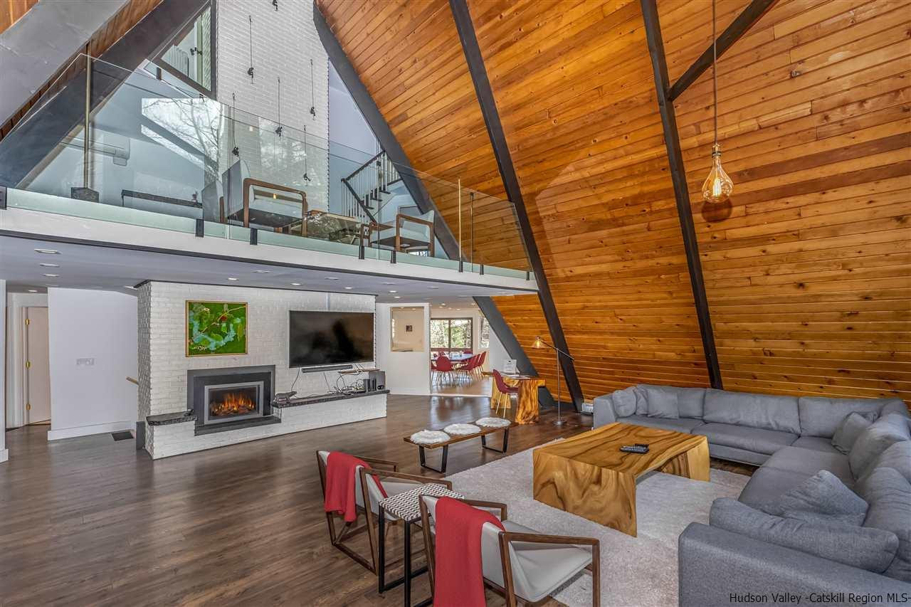 96 Lake Road Hunter, NY 12442 - Photo 9 of 35 a view of living room kitchen with furniture and fireplace