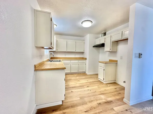 a kitchen with a sink cabinets and stainless steel appliances