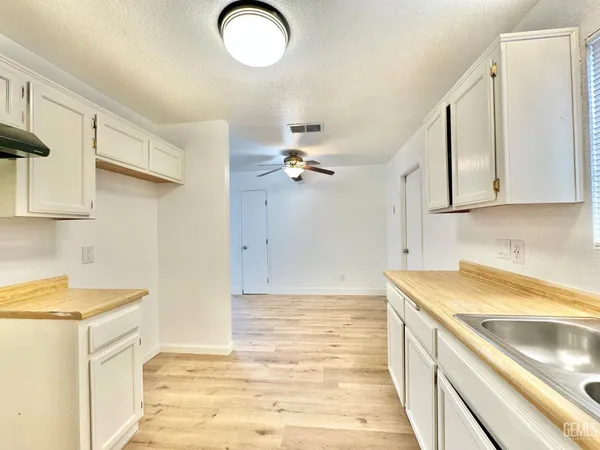 a kitchen with a sink cabinets and appliances