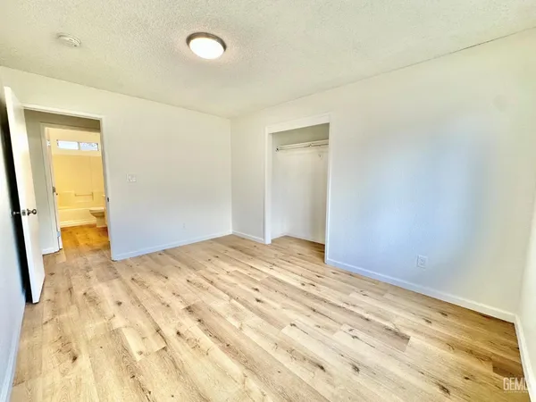 a view of a room with wooden floor and bathroom