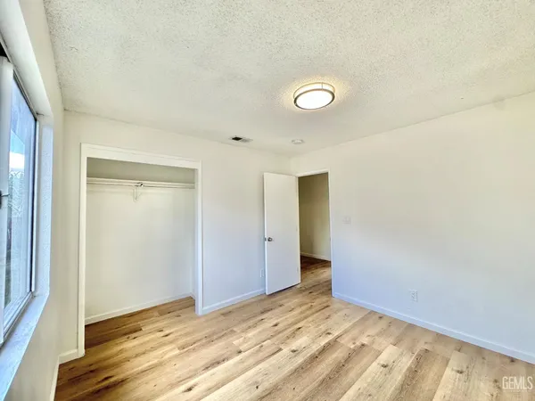 a view of an empty room and wooden floor
