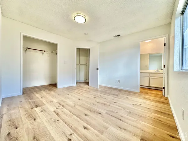 a view of an empty room and wooden floor