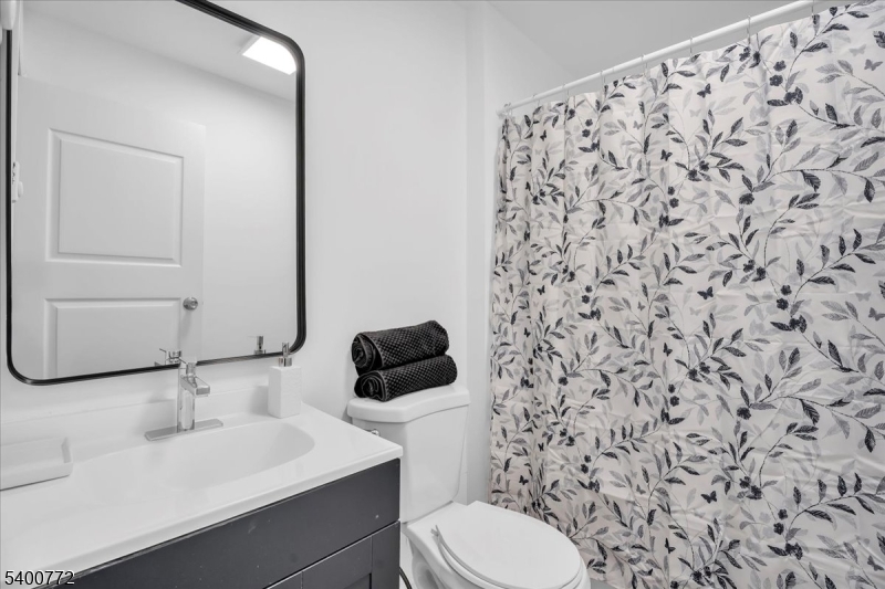 348 Silk Street Lawnside, NJ 08045 - Photo 12 of 24 a bathroom with a toilet and a sink