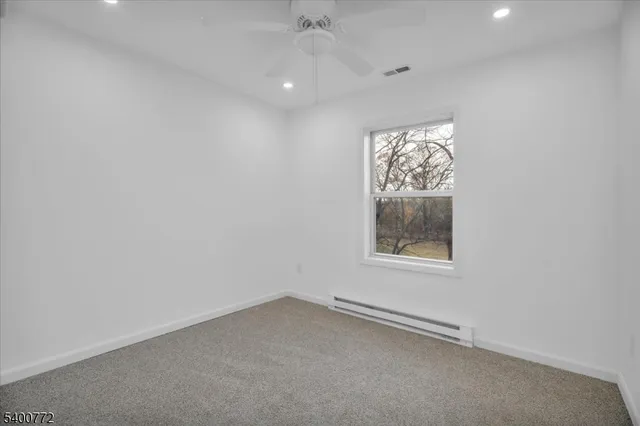 an empty room with an entryway and closet