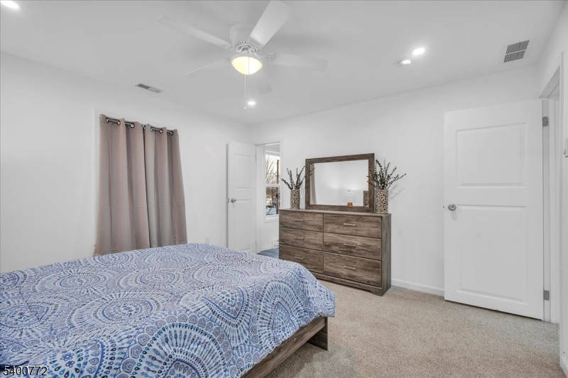 348 Silk Street Lawnside, NJ 08045 - Photo 19 of 24 a bedroom with a bed and a dresser