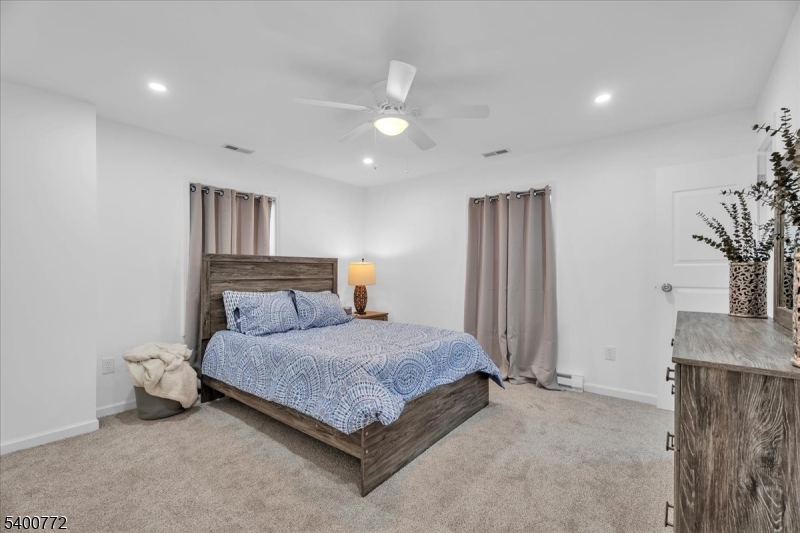 348 Silk Street Lawnside, NJ 08045 - Photo 20 of 24 a bedroom with a bed and a potted plant on dresser