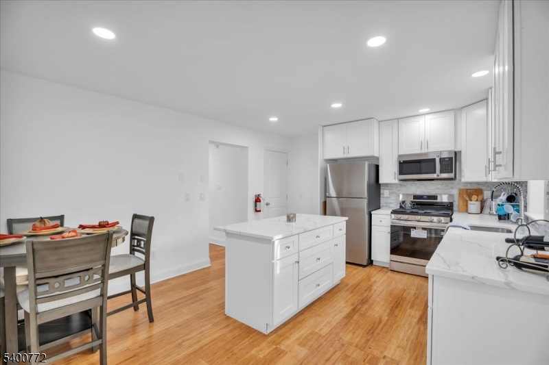 348 Silk Street Lawnside, NJ 08045 - Photo 6 of 24 a kitchen that has a lot of cabinets and wooden floor