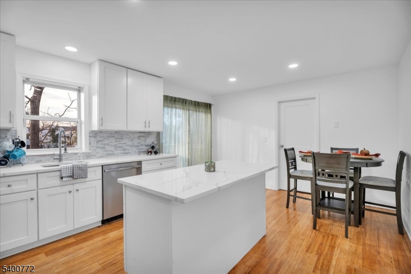 348 Silk Street Lawnside, NJ 08045 - Photo 7 of 24 a large white kitchen with a table and chairs