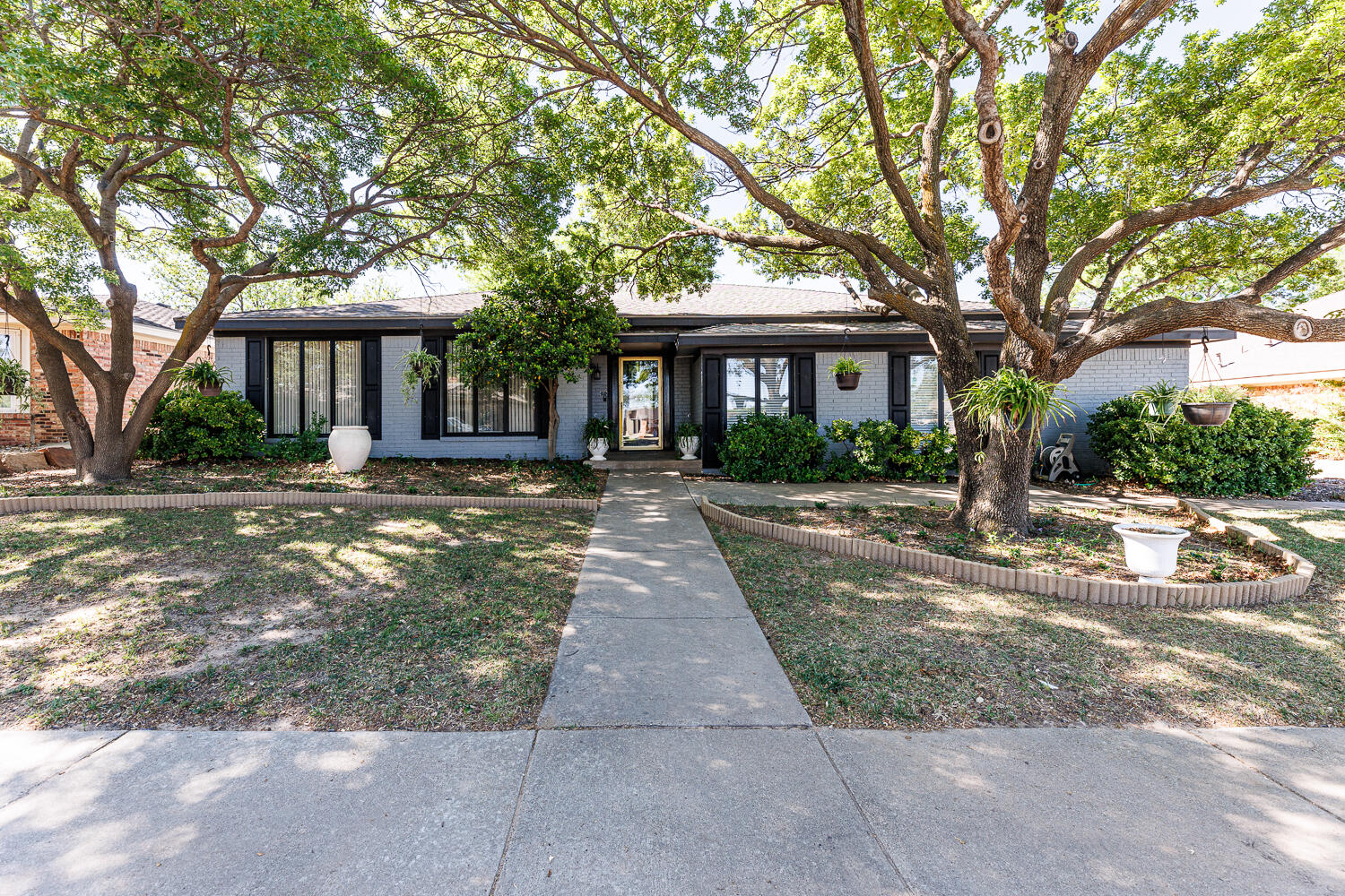 3713 95th Street Lubbock, TX 79423 - Photo 1 of 70 a front view of a house with yard and green space