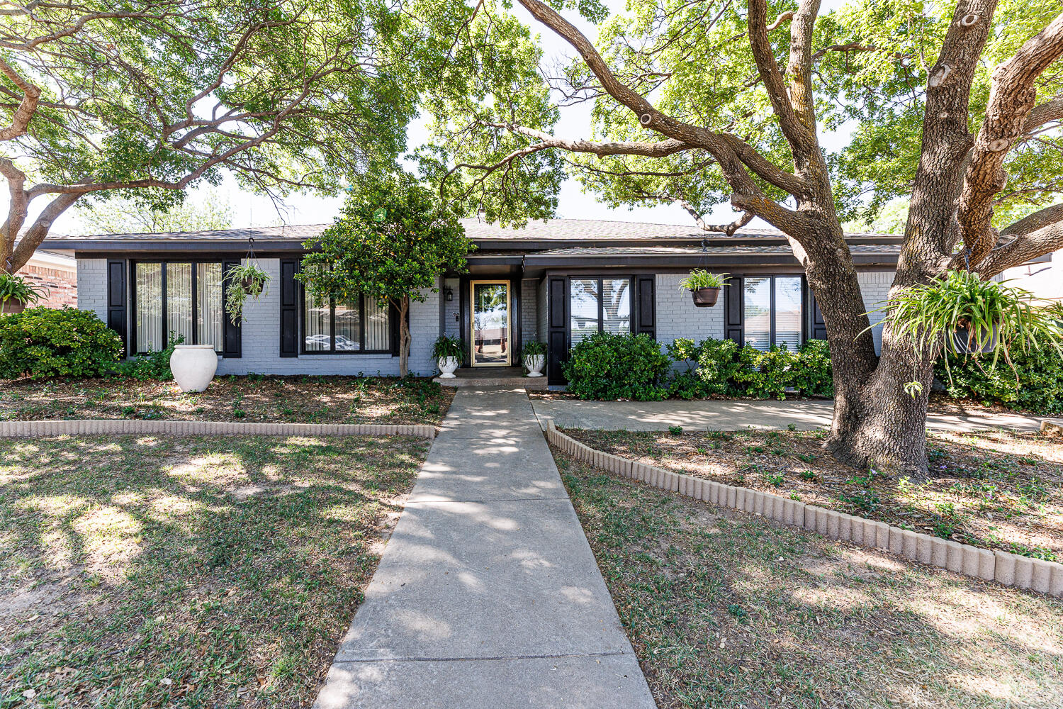 3713 95th Street Lubbock, TX 79423 - Photo 2 of 70 a front view of a house with yard and green space
