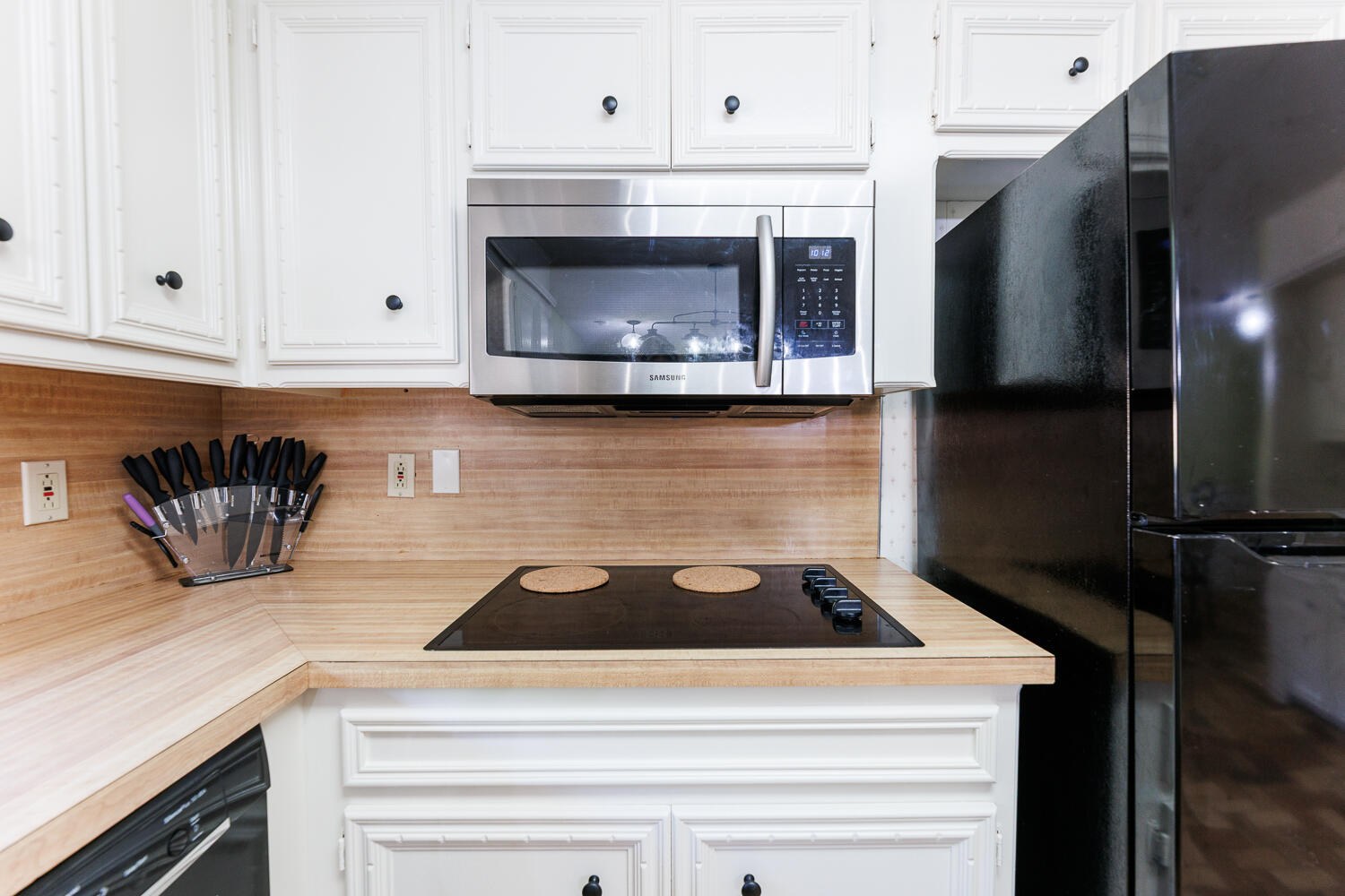 3713 95th Street Lubbock, TX 79423 - Photo 22 of 70 a kitchen with granite countertop white cabinets and stainless steel appliances