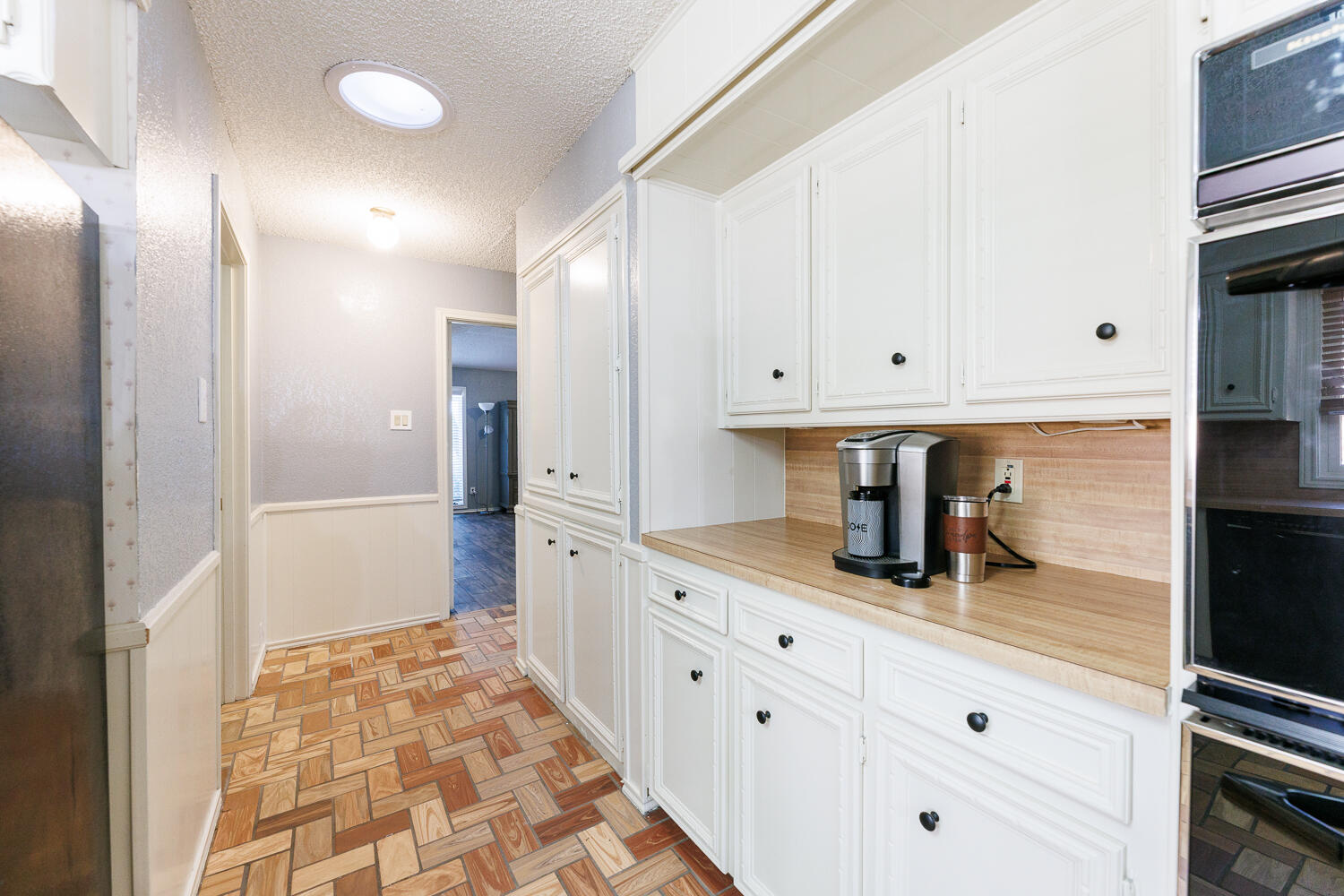 3713 95th Street Lubbock, TX 79423 - Photo 24 of 70 a kitchen with granite countertop white cabinets and stainless steel appliances