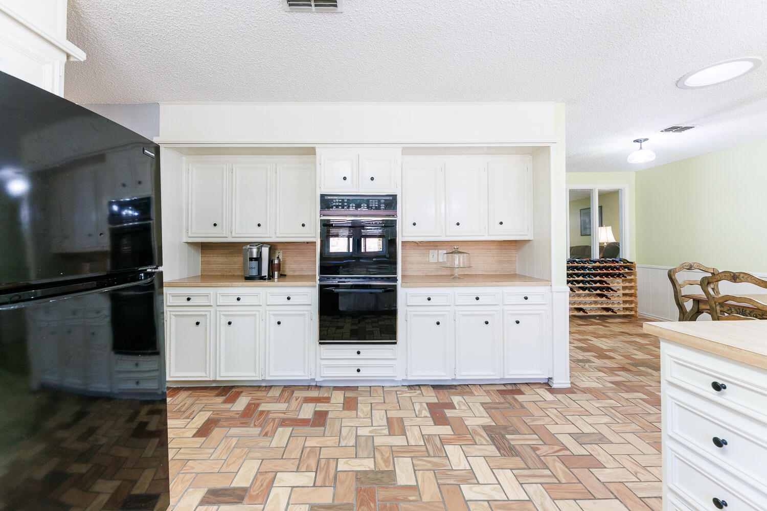3713 95th Street Lubbock, TX 79423 - Photo 25 of 70 a kitchen with stainless steel appliances a stove a refrigerator a sink and white cabinets